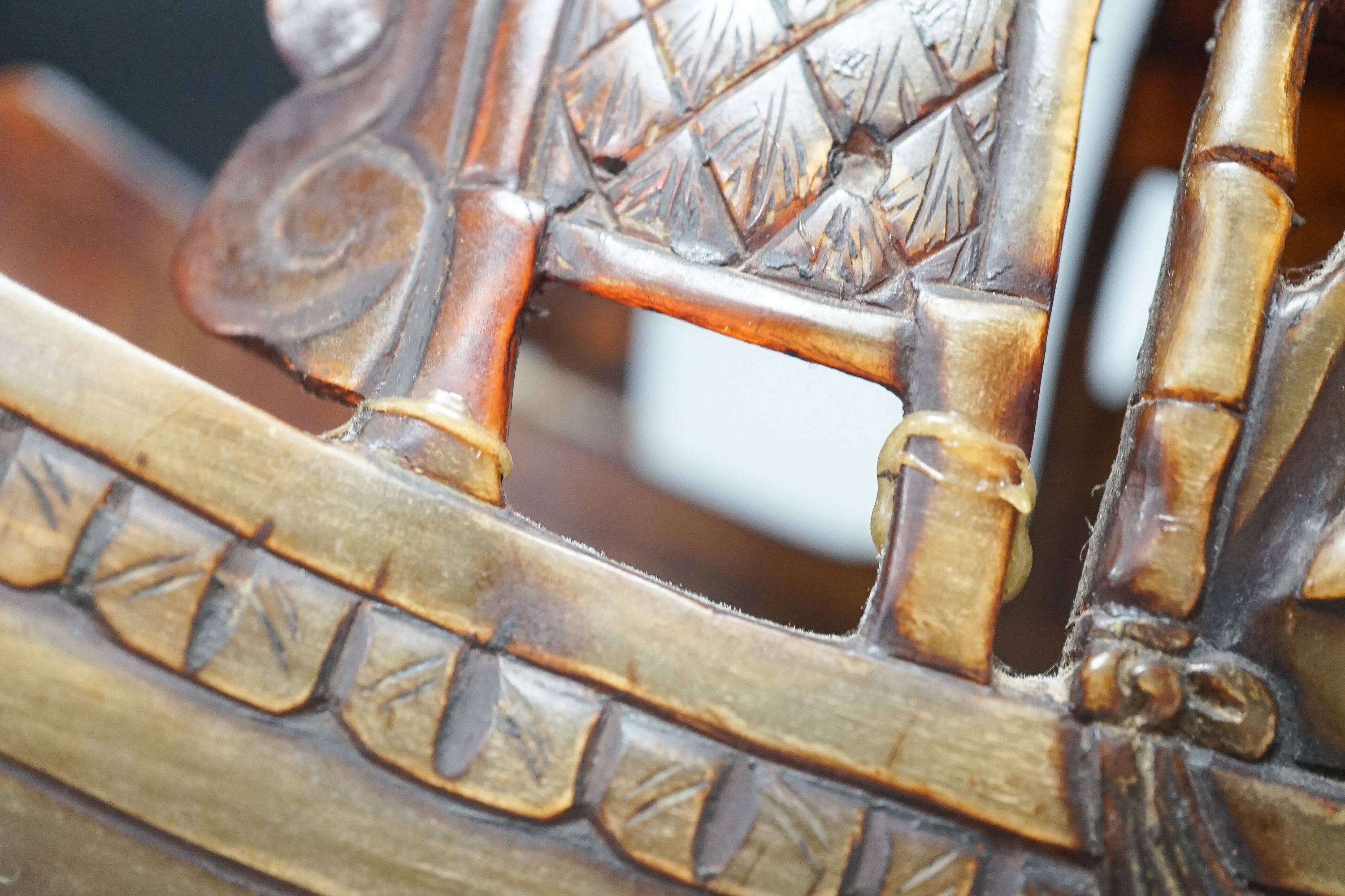 A Chinese horn carving of a junk boat, wood stand, 34cm